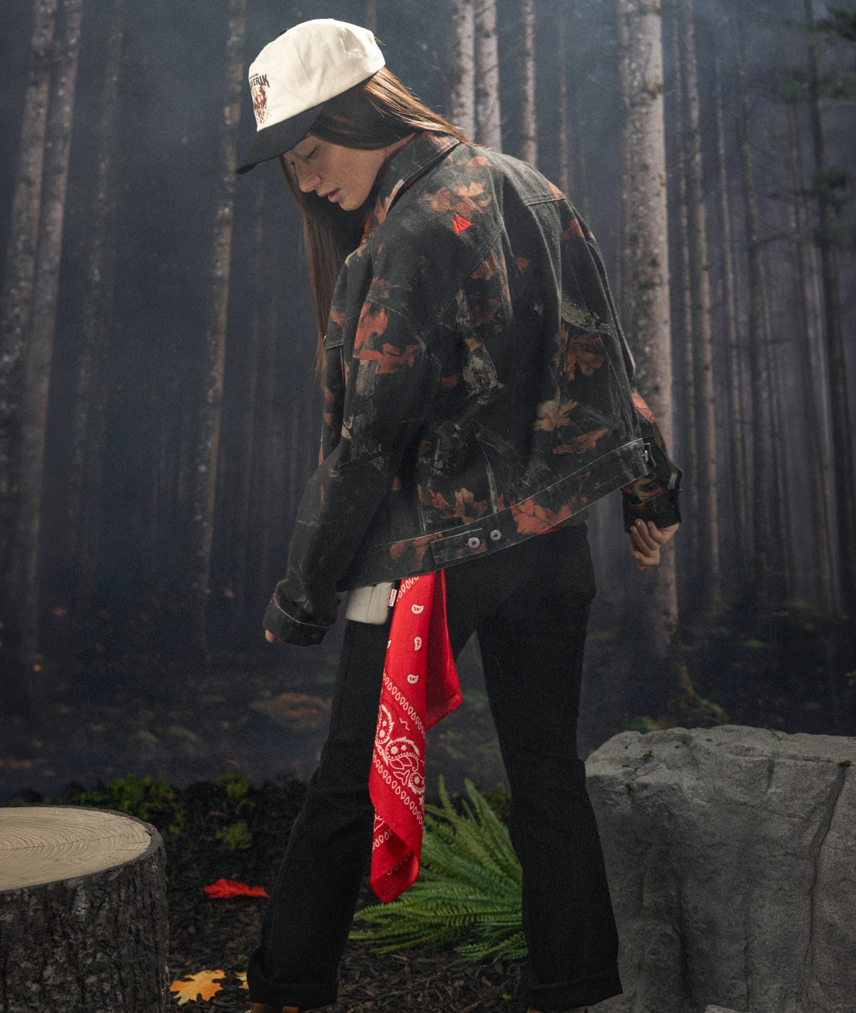 Maverik black camo leaf jacket in the fall with a female wearing it